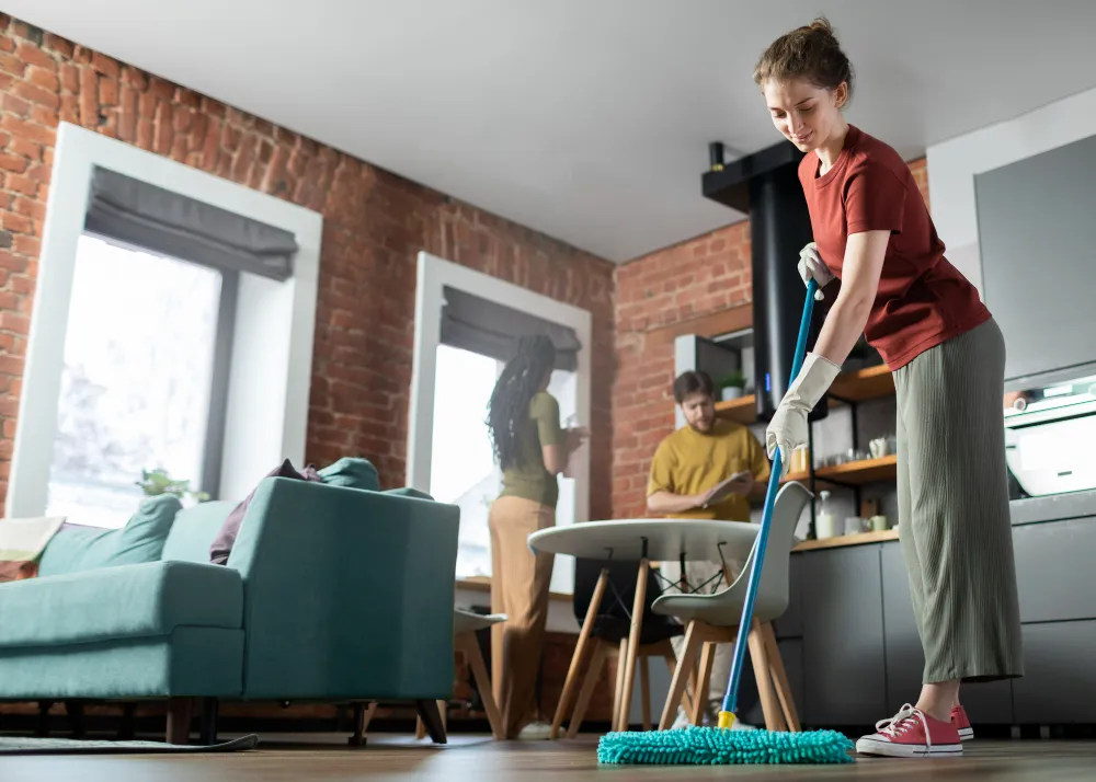 Full shot people cleaning room together_converted