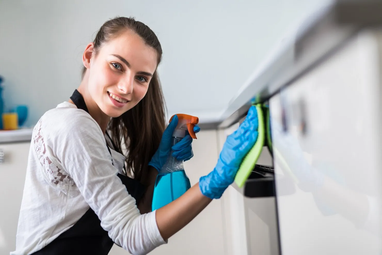 beautiful-young-woman-protective-gloves-cleaning-oven-with-rag_231208-551_converted